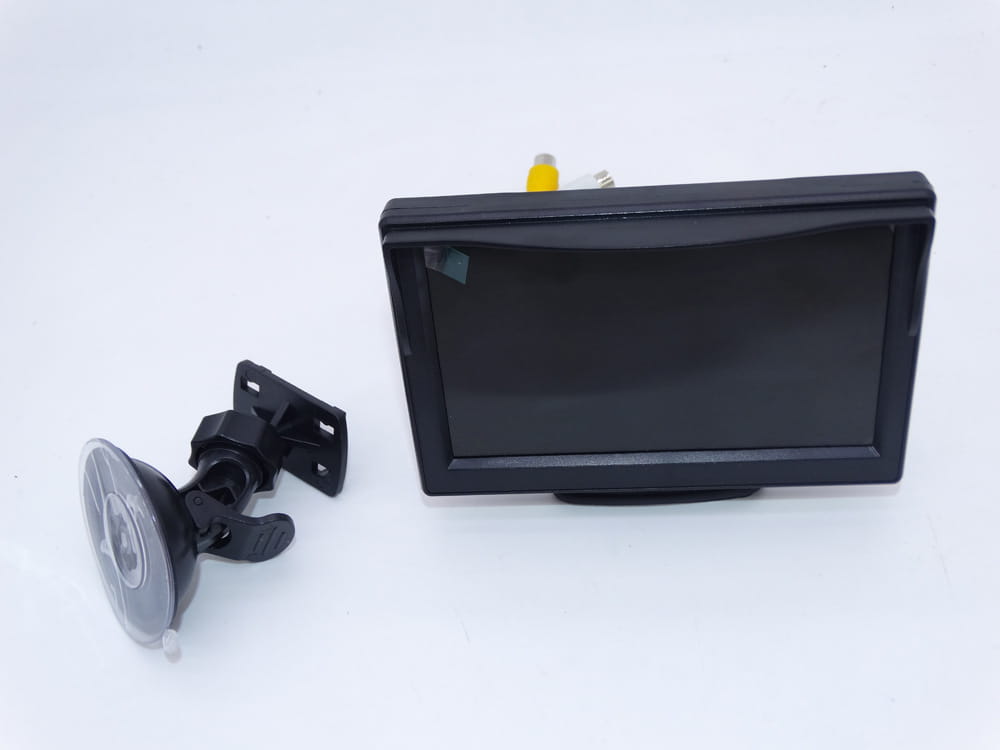 black rectangular 7 inch wireless suction cup display hd rearview monitor with suction cup mount showing the back side of the device