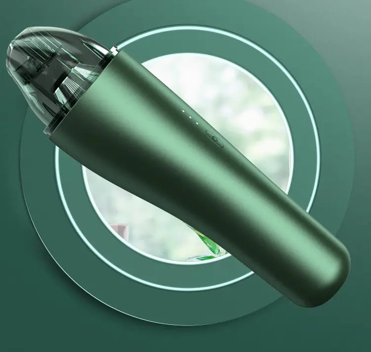 A sleek matte green wireless vacuum cleaner with a transparent nozzle and subtle led indicator lights designed for car and household use.
