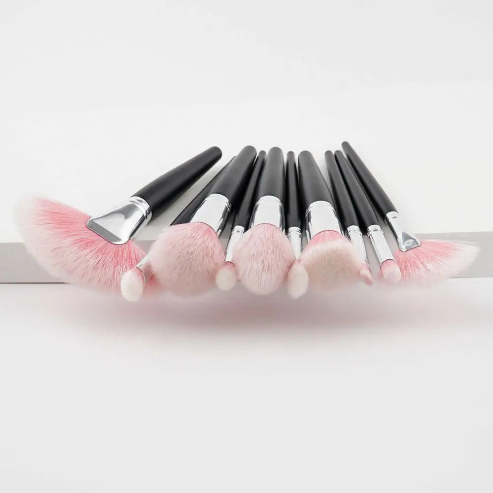 Set of eight pink and black professional makeup brushes with silver ferrules from the 10 piece purple gradient makeup set