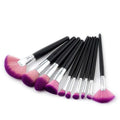 Set of ten professional makeup brushes with black handles, silver ferrules, and purple gradient makeup bristles