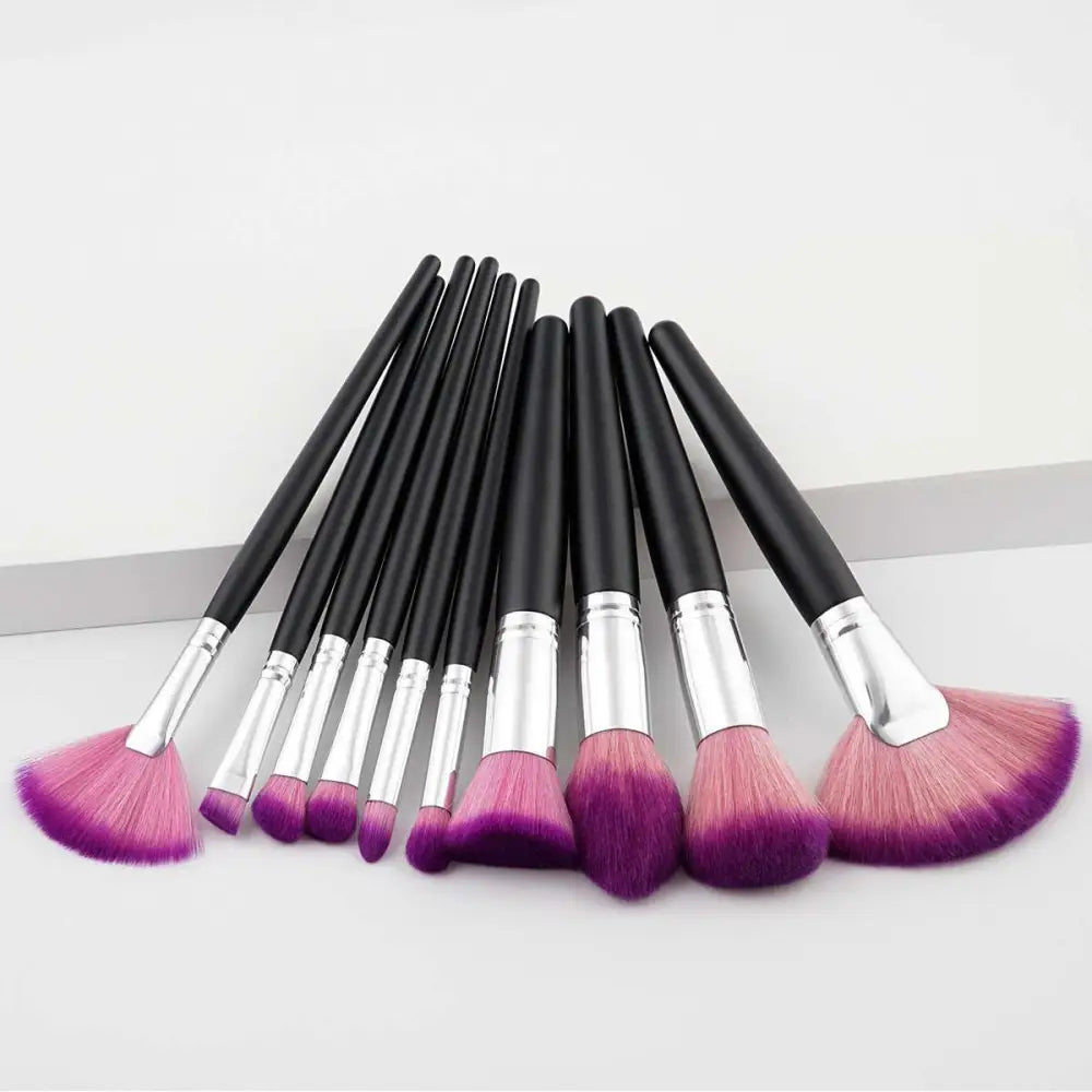 Set of ten professional makeup brushes with black handles, silver ferrules, and purple gradient makeup bristles