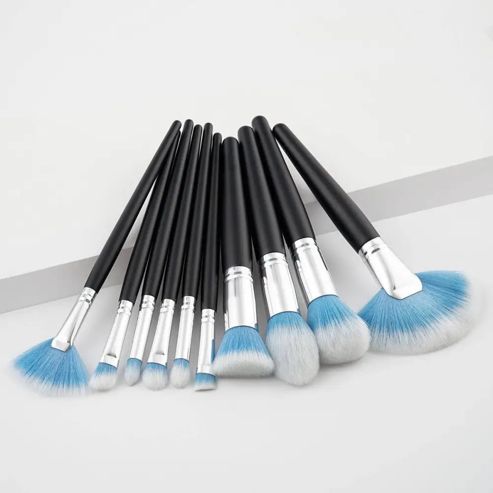 Set of ten professional makeup brushes with black handles silver ferrules and purple gradient synthetic bristles