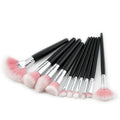 Set of ten professional makeup brushes with soft pink bristles silver ferrules and black handles for purple gradient makeup