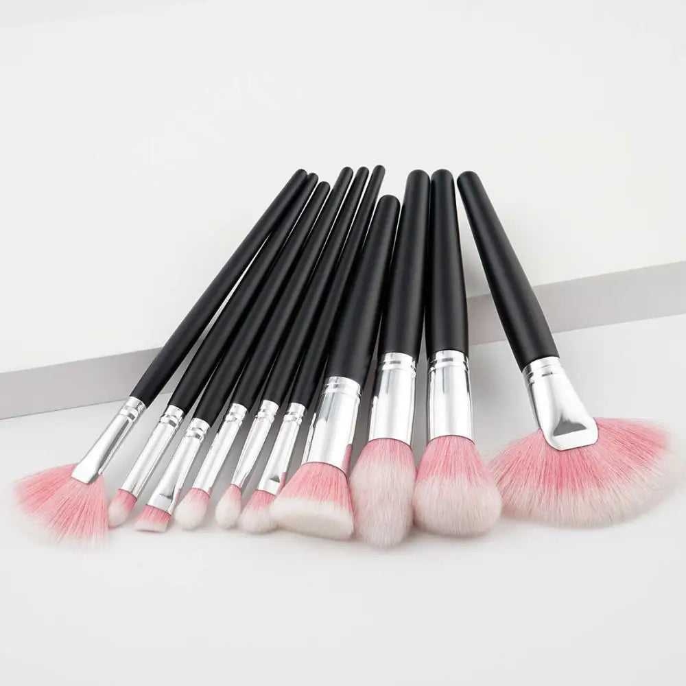 Set of ten professional makeup brushes with black handles, silver ferrules, and purple gradient makeup bristles