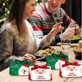 Green and red christmas candy boxes featuring santa claus christmas faces with festive ribbon bows for holiday gifting