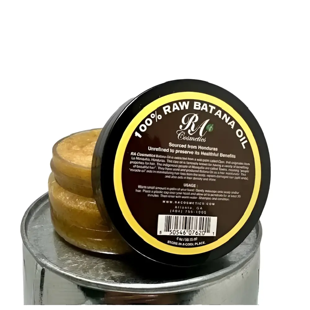 A round dark brown jar with black lid and yellow border contains 100 percent raw natural batana hair oil from r&g cosmetics