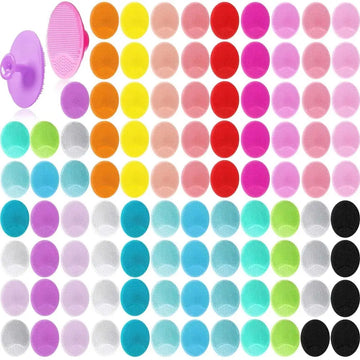 A 100 piece silicone face scrubber set featuring vibrant facial cleansing brushes in assorted colors and patterns including purple