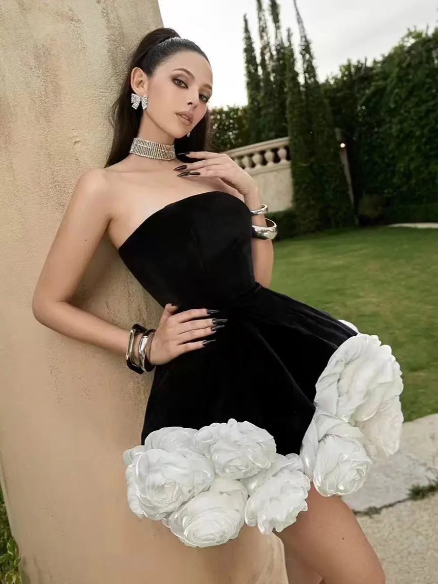 black velvet strapless mini dress featuring voluminous white flower pettiskirt french ruffles at the hem and a short skirt silhouette