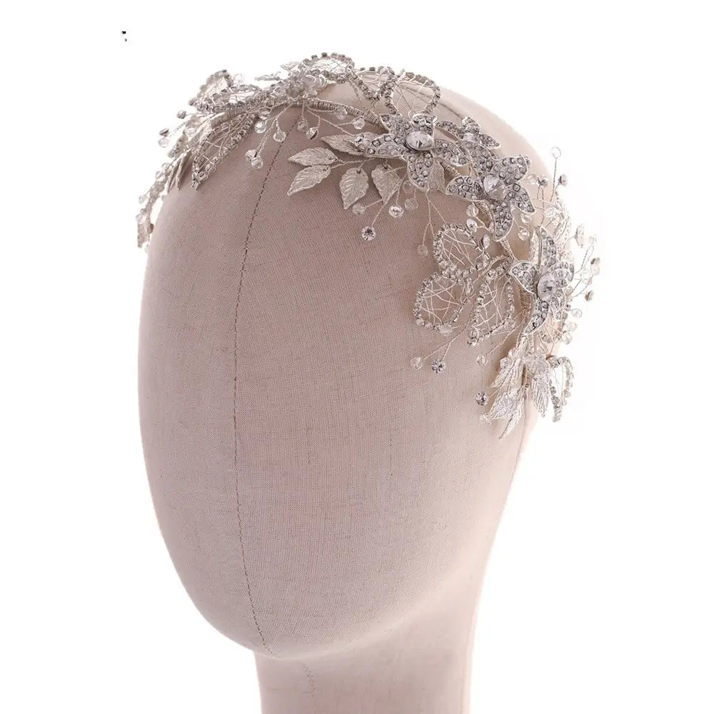 Handmade environmentally friendly silver floral headpiece crafted from environmentally friendly alloy featuring intricate lace sparkling crystals and delicate leaf motifs.
