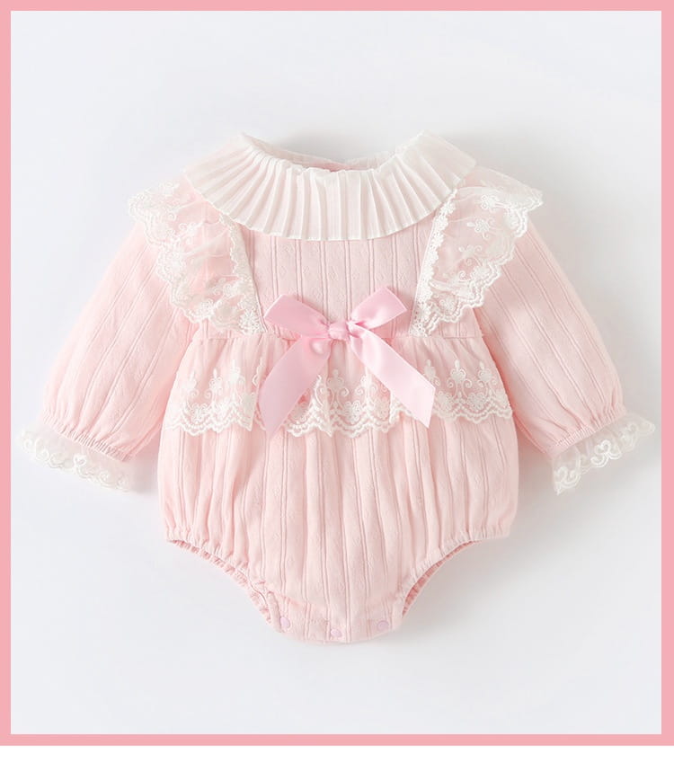 a delicate pink ribbed long sleeve newborn clothes jumpsuit featuring lace trim and a matching bow at the front ideal for autumn wear