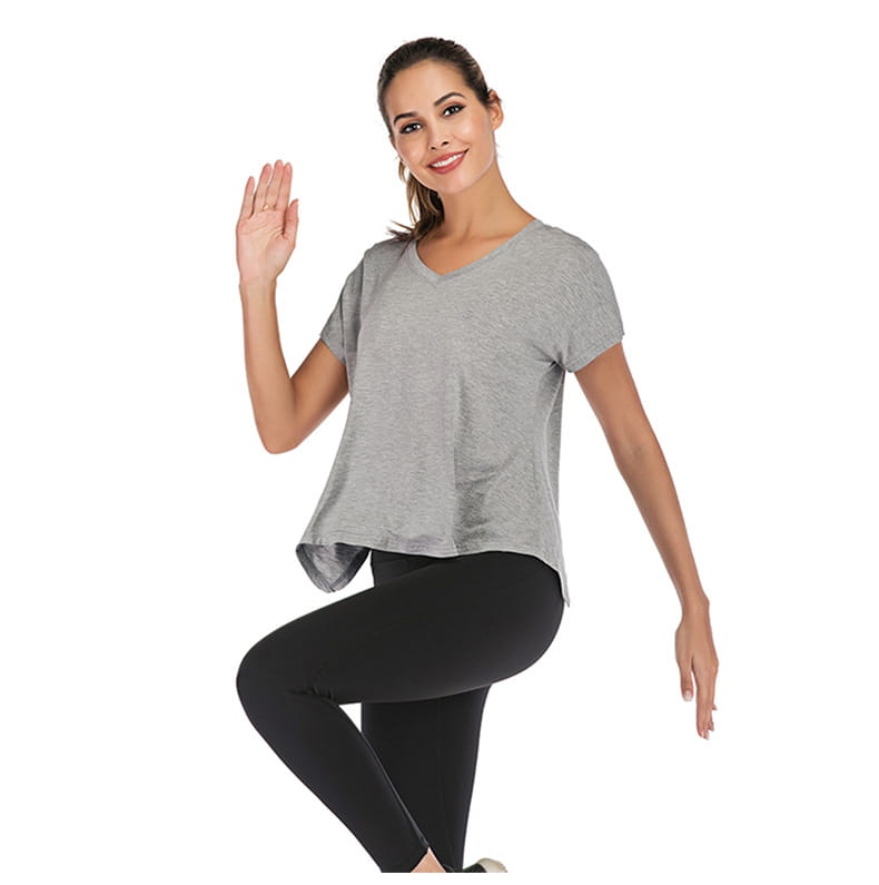 A soft heather gray v-neck sports t-shirt with short sleeves, relaxed fit, and slightly asymmetrical hemline designed for women.