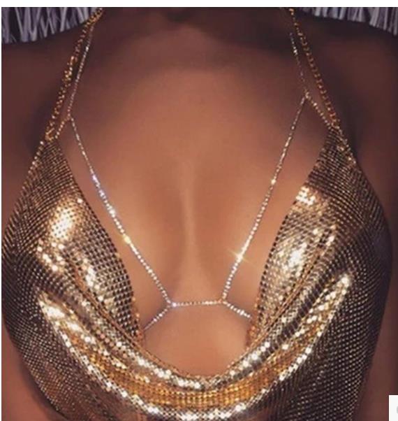 gold mesh body chain with sparkling rhinestone accents styled as rhinestone body jewelry necklace paired with champagne satin blouse