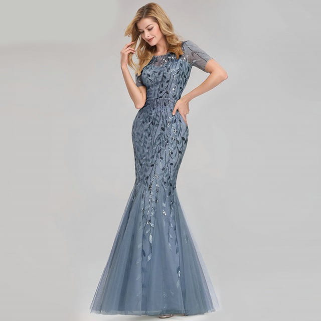 A shimmering slate blue temperament mermaid dress featuring intricate gold leaf-patterned beading and sheer mesh sleeves.