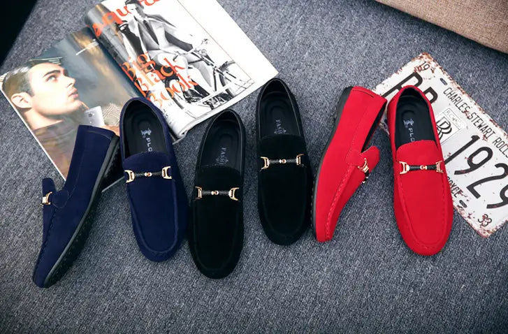 A pair of navy blue suede casual shoes peas featuring gold-tone horsebit buckle detailing.