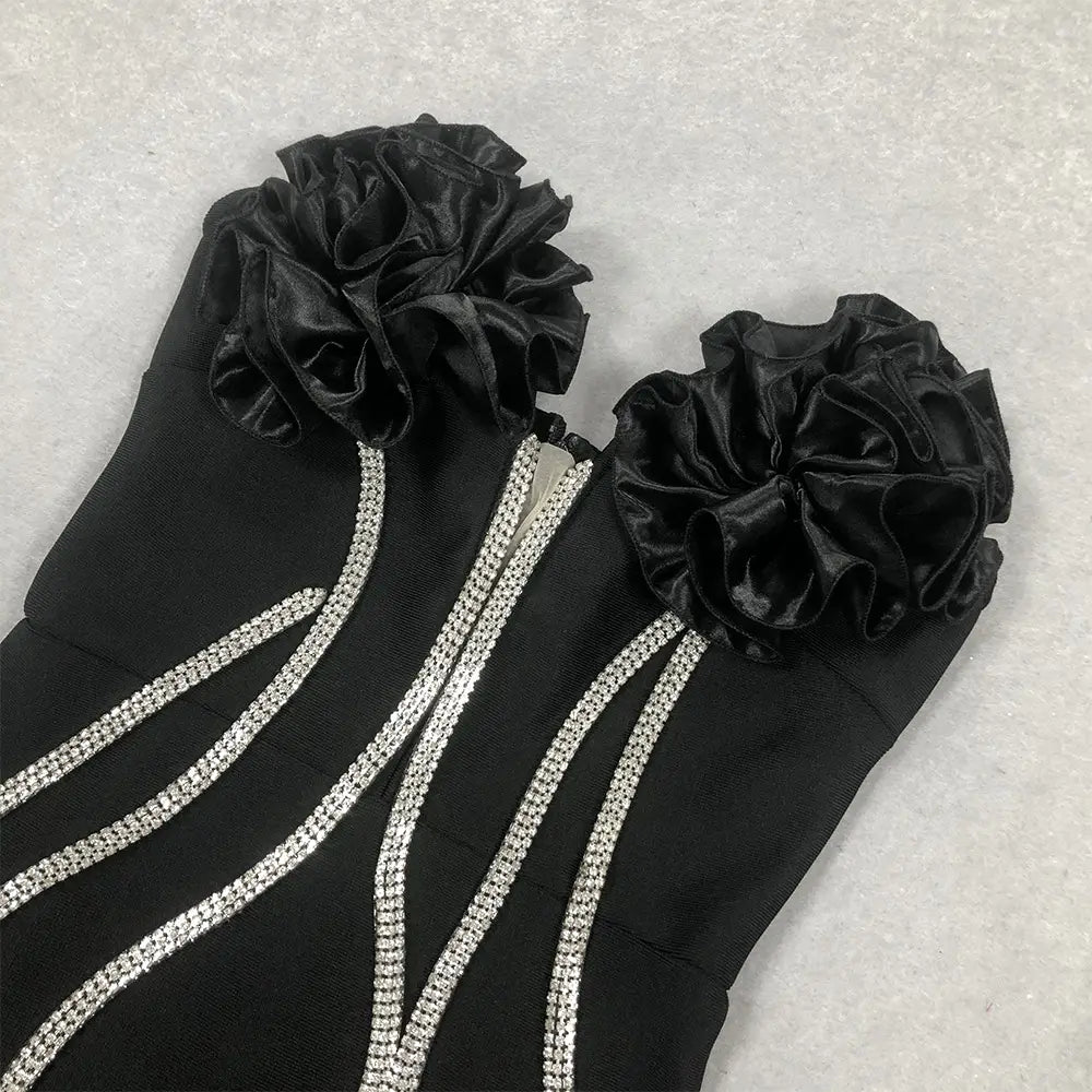 black satin ruffled flower embellishments adorn the shoulders of a black white temperament socialite flower chain evening dress with silver rhinestone trim.
