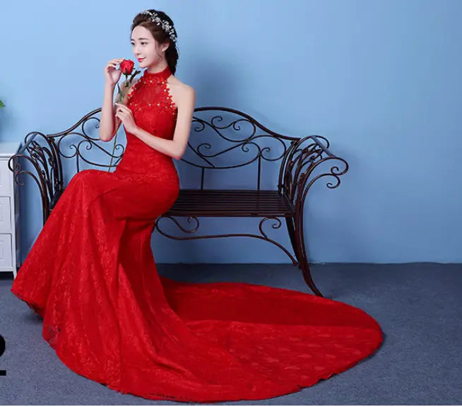 A vibrant red lace mermaid wedding dress with a high neckline and an elegant train showcasing a flattering size waist for a big red wedding.