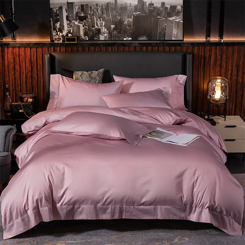 A luxurious pink satin four-piece bed set featuring a matching duvet cover pillowcases and sham from the purple satin embroidered four-piece bed sheet collection.
