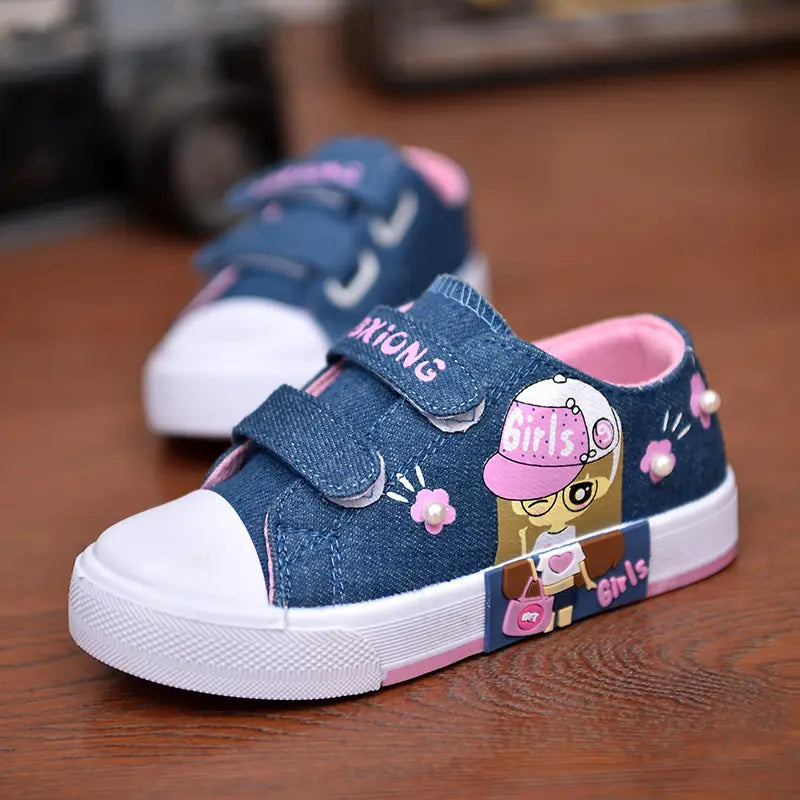 blue denim girls canvas shoes featuring pink velcro straps white rubber toe caps soles cartoon girl design with girls text and pearl embellishments