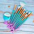 Set of 11pcs mermaid makeup brushes featuring iridescent teal and purple scales with gold ferrules and white bristles