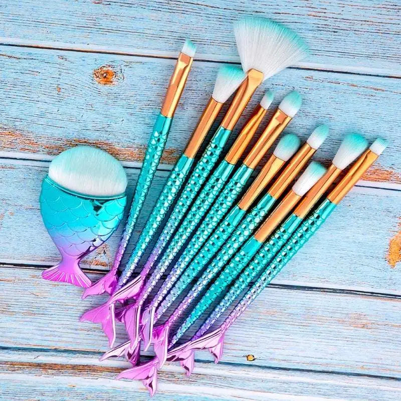Set of 11pcs mermaid makeup brushes featuring iridescent teal and purple scales with gold ferrules and white bristles