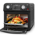 Black 12 liter air fryer oven with dual knob control and glass door roasting turkey and vegetables inside
