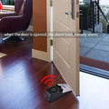 Black plastic 120db electronic burglar alarm wedge door stop with circular button and wireless signal indicator