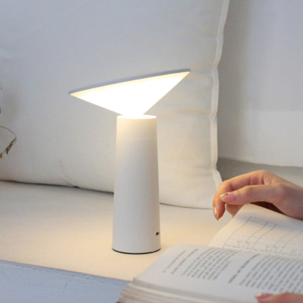 A sleek white cylindrical minimalist touch table lamp usb led set featuring a triangular softly glowing light diffuser ideal for led reading.