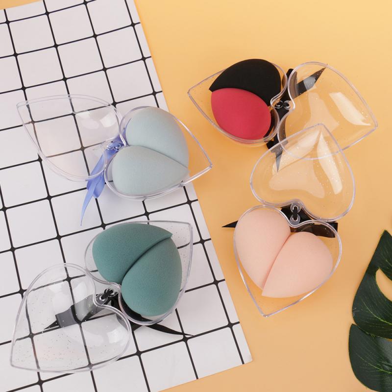 heart shaped beauty egg makeup sponges in pastel and bold colors each inside a clear plastic case with a black clip in a gift box