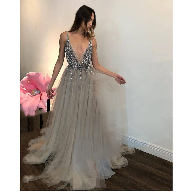 a shimmering silver beaded diamond grey banquet evening dress with a deep v neckline and flowing tulle skirt suitable for grey banquet party events