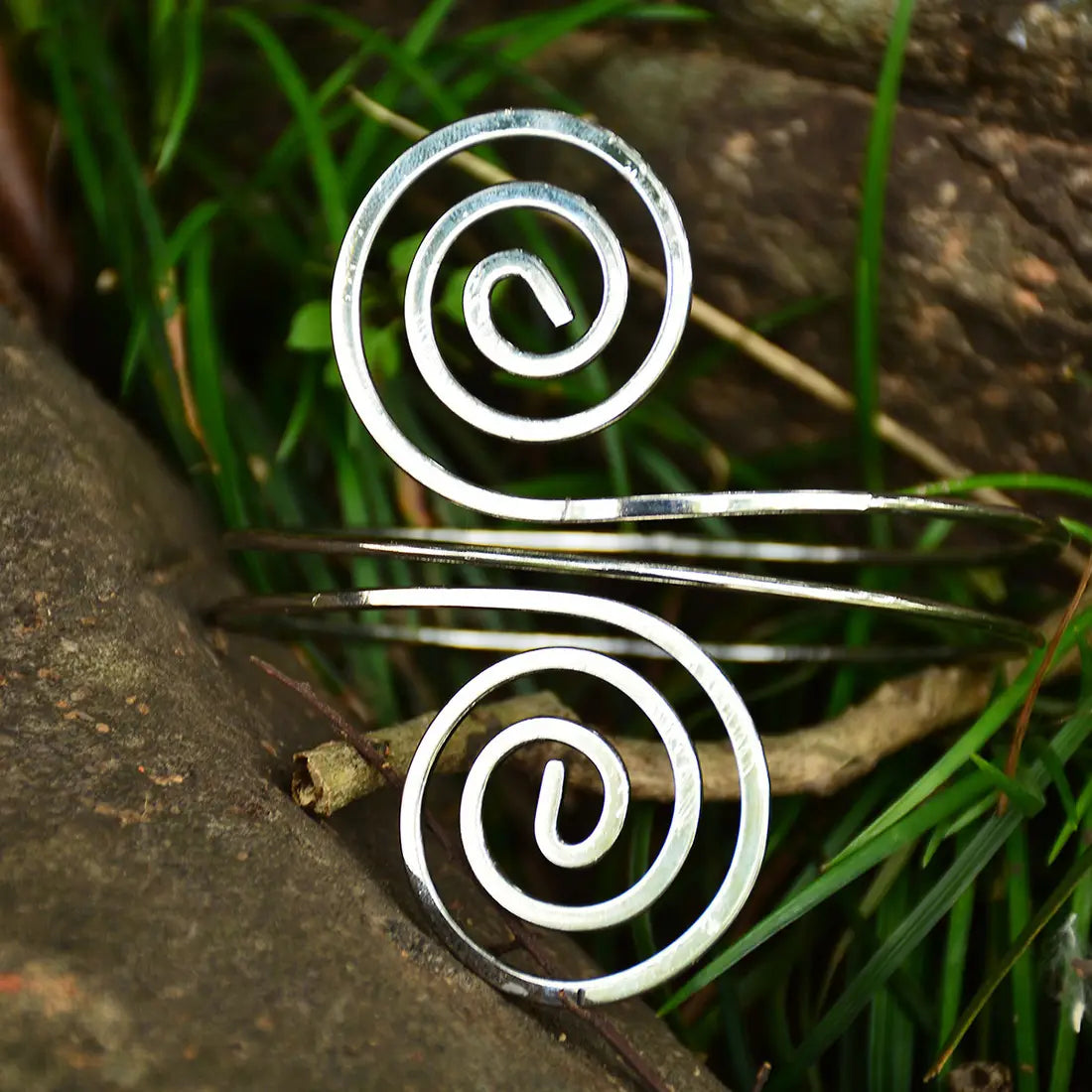 Silver spiral wire arm ring jewelry with a polished reflective finish featuring two distinct coiled designs, part of gold minimalist spiral arm ring jewelry collection.