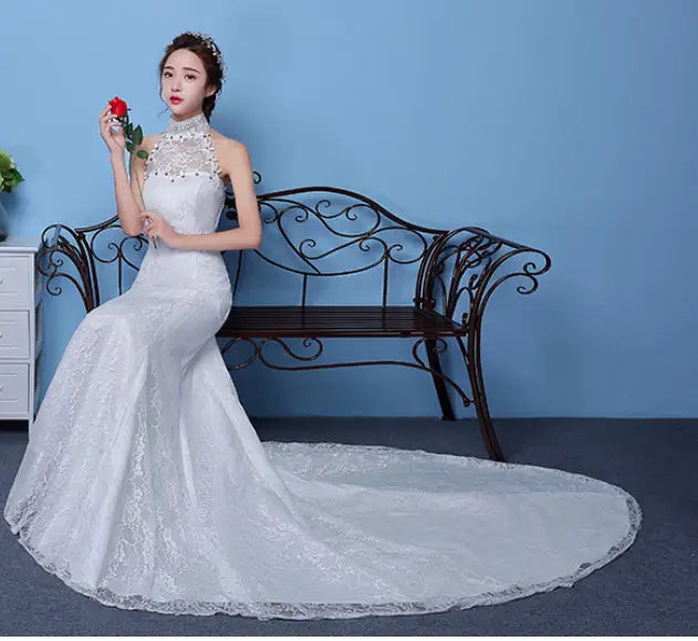 A white lace mermaid-style wedding dress with a high neckline and intricate beading details from the big red wedding collection.