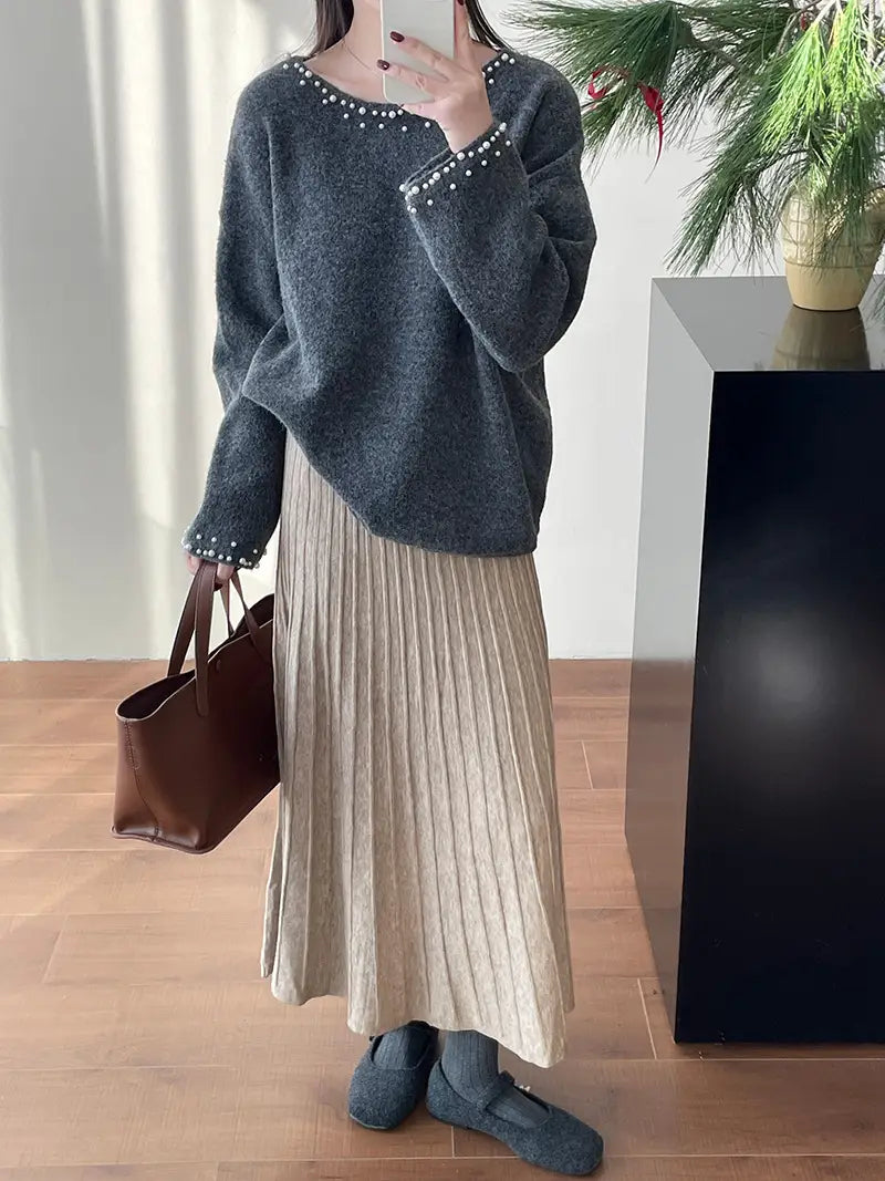gray knit sweater with pearl embellishments along the neckline and cuffs paired with korean elastic waist knitted pleated midi skirt.
