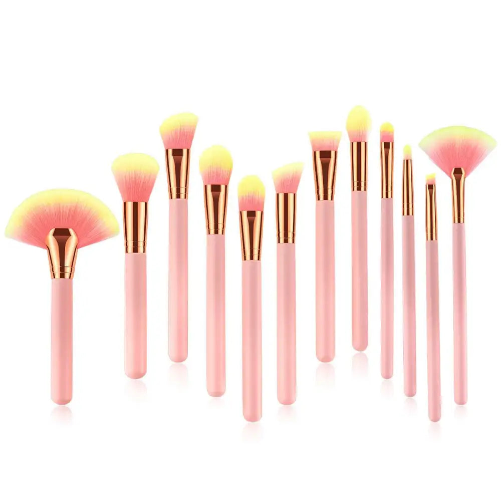 Set of 12pcs beauty makeup brushes with pink and gold handles and gradient yellow to pink bristles for versatile use