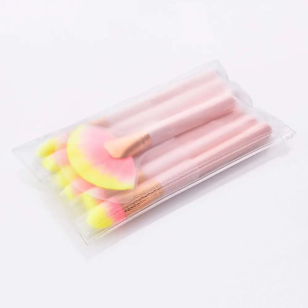 Set of 12pcs beauty makeup brushes with pink and yellow gradient bristles and gold handles in clear plastic packaging
