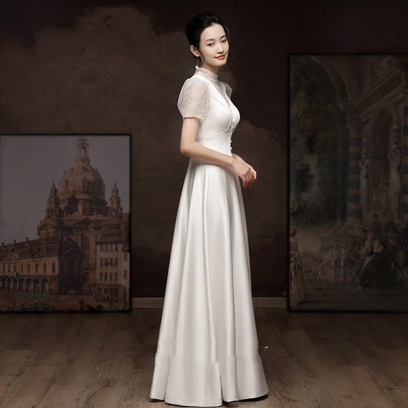 White satin puff sleeve engagement wedding dress featuring a flowing gown with sheer short sleeves and a high neckline.
