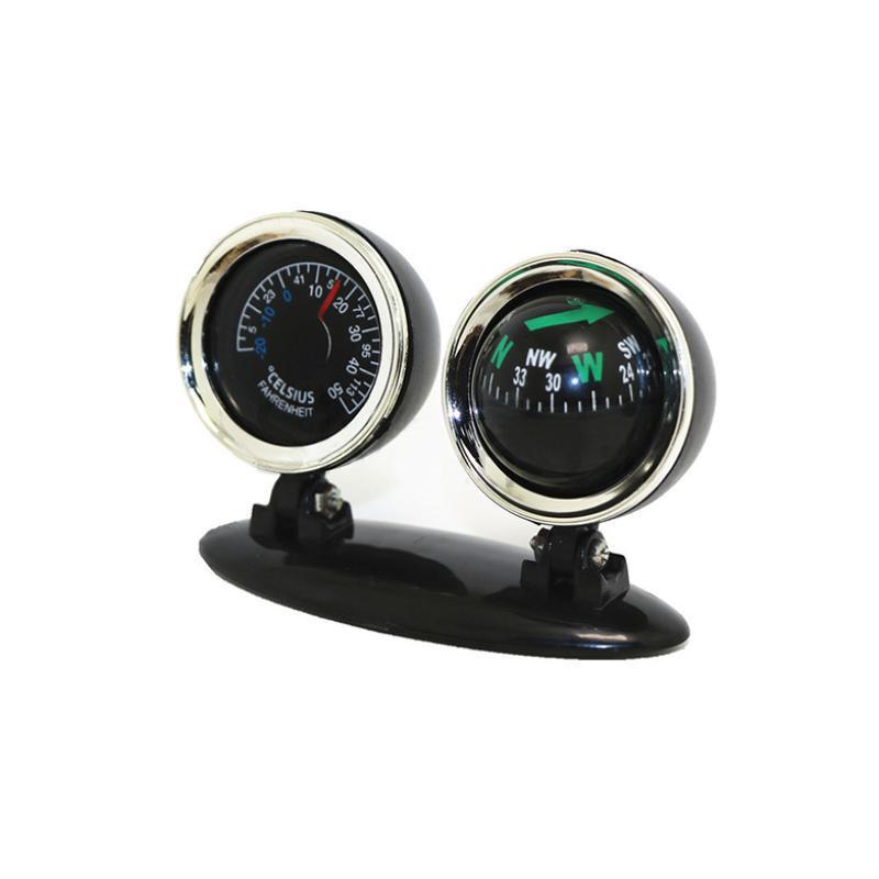 black dual-function car dashboard accessory with chrome-rimmed circular gauges featuring a seat car compass with green directional indicators and a temperature gauge displaying celsius and fahrenheit