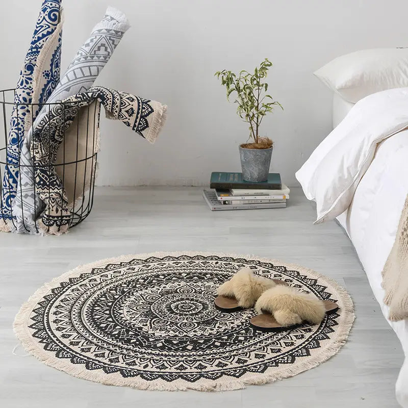 Navy mandala ethnic style round carpet floor mat featuring a circular black and white mandala design with fringed edges.