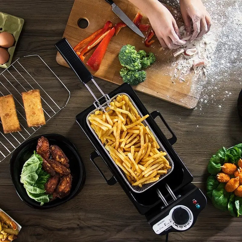 Black 3l electric french fries fryer with metal basket filled with golden french fries and control knobs on the front for convenient frying.