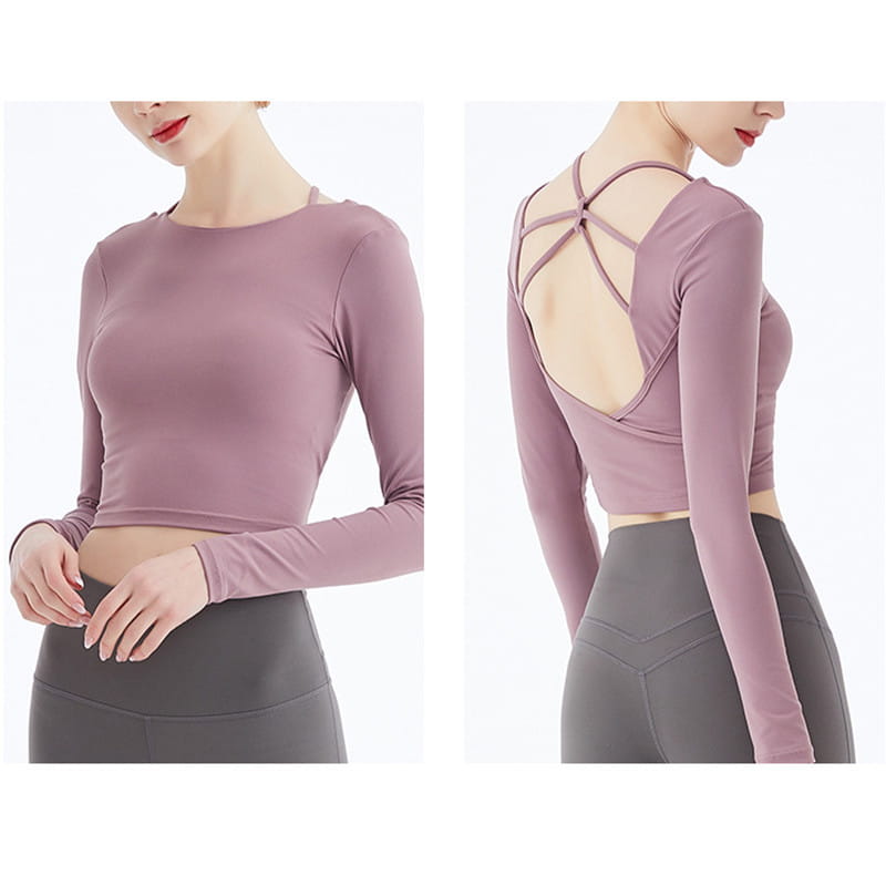 A mauve long sleeve yoga crop top with stretchy fabric and a crisscross strap long sleeve design shown from the back.