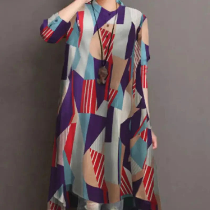 A woman wearing a ladies retro casual sleeve loose shirt dress featuring a high waist tunic design with an abstract geometric pattern in bold red purple blue and beige tones.