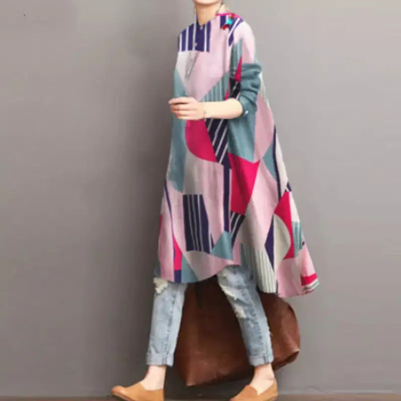 A ladies retro casual long loose-fitting tunic dress featuring a vibrant geometric pattern of pink teal and navy stripes and blocks, designed as a sleeve loose shirt with a high waist.