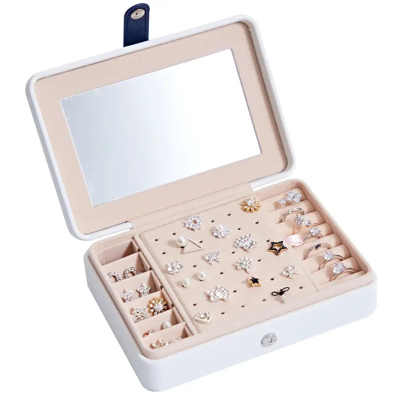 White rectangular multifunctional jewelry storage box with built-in mirror and soft pink interior featuring organized compartments for earrings and rings.