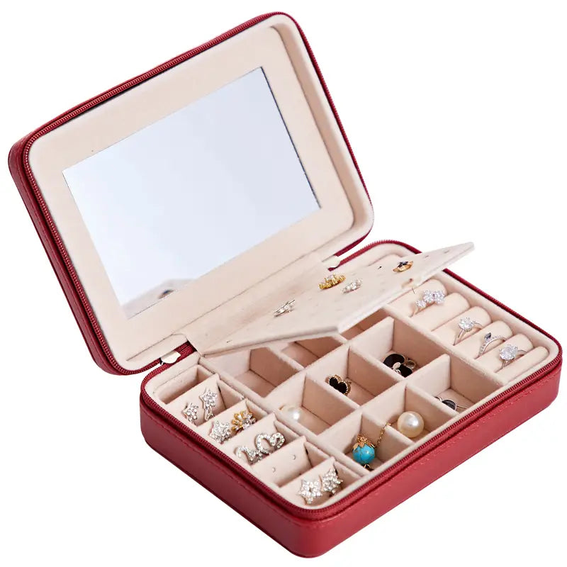 Red leather multifunctional jewelry storage box with built-in mirror and segmented compartments for earrings rings and necklaces.