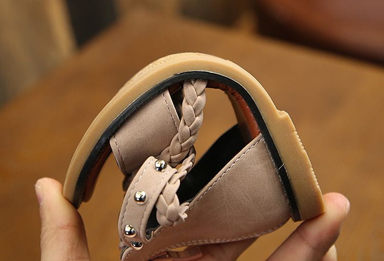 Girls braided beige leather sandals with silver toned studs and tan rubber sole showing yards internal length.