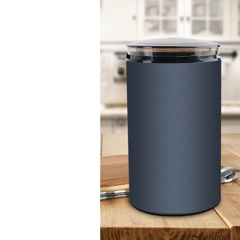 dark gray electric herb grinder with transparent base and clear lid featuring black accents designed for grinding herbal and coffee ingredients