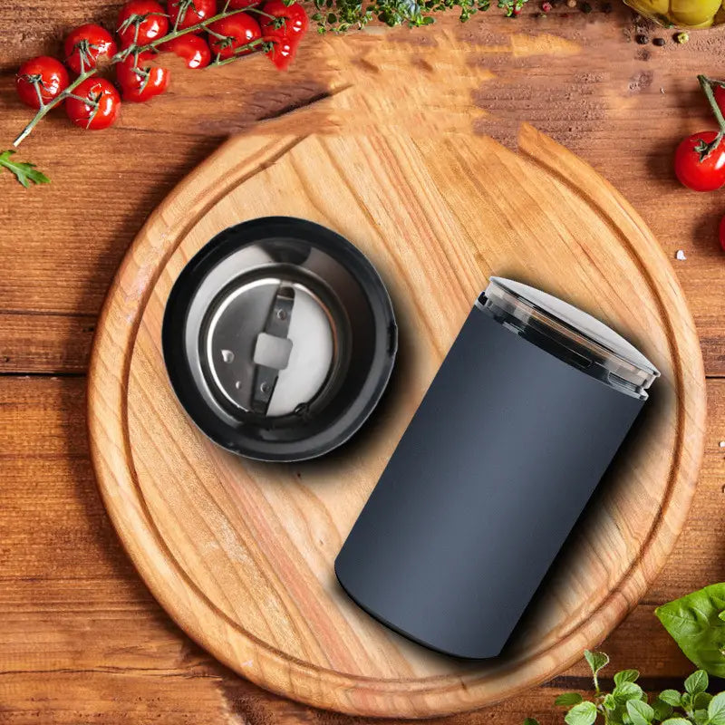 Black matte finish electric herb grinder with transparent lid and detachable blade assembly designed for grinding herbal coffee and spices.