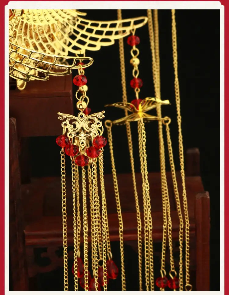 Golden ornate wedding Chinese Xiuhe hairpins with ear clip featuring red crystal beads and intricate filigree designs presented in a gift box.