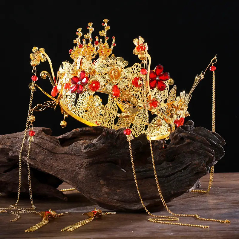 Golden ornate wedding Chinese Xiuhe headdress with ear clip featuring golden filigree, vibrant red floral embellishments, and dangling chain tassels, perfect for bridal wear and gift box presentation.