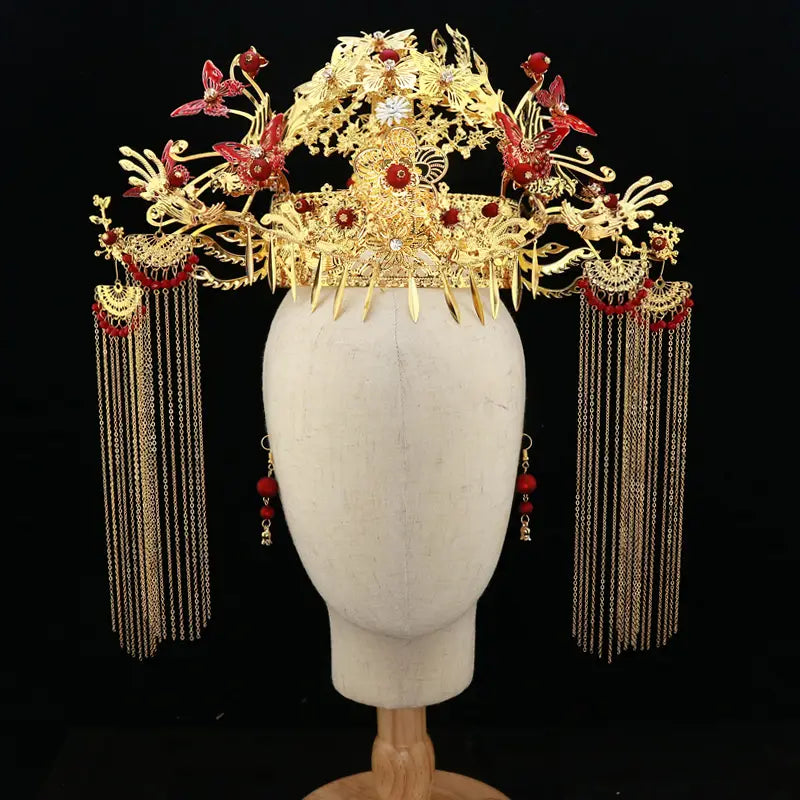 Golden ornate wedding Chinese Xiuhe headdress with ear clip featuring red butterfly accents, floral motifs, and dangling chain tassels, ideal for bridal occasions and gift box presentation.