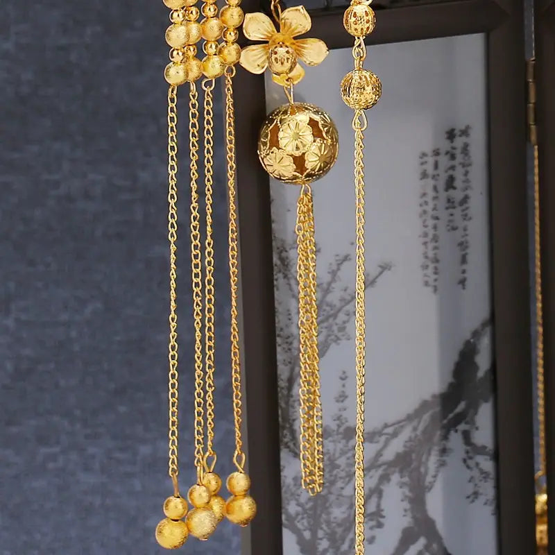 Golden ornamental hairpin with intricate floral and spherical designs and dangling chains and beads for tassel suit wedding cheongsam hair accessories.